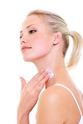 woman applying moisturizer cream on her neck